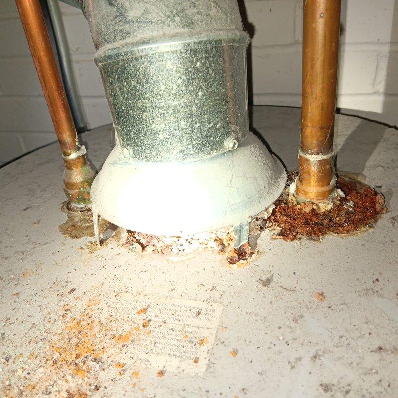 Responded to complaint of water draining from bathroom sink directly onto basement floor. Upon inspection, discovered improper drain installation where sink tailpiece discharged directly to basement floor rather than connecting to proper waste line. Identified severe corrosion and rust buildup at copper pipe connections near galvanized ductwork in basement, indicating long-term moisture exposure from misdirected drainage. Documented existing Moen centerset faucet installation at bathroom sink and traced drainage path to determine scope of correction needed. Recommended proper P-trap installation and connection to sanitary waste system to resolve code violations and prevent continued water damage to basement floor and structural components.