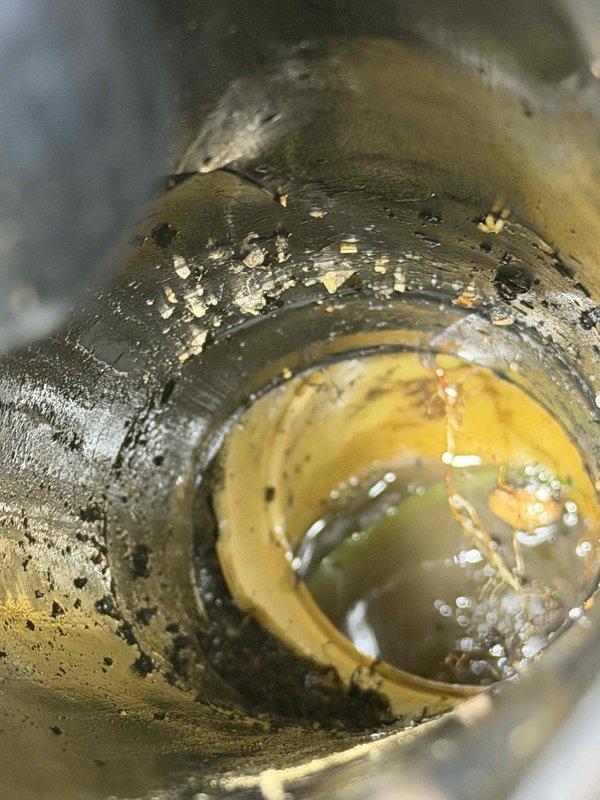 Performed second-opinion camera inspection of storm drain system to assess blockages and potential pipe collapse in yard area. Inspection revealed significant deterioration of drain assembly with mineral buildup, debris accumulation, and compromised pipe integrity at marked location, confirming concerns identified by previous contractor. Documented findings with photographic evidence showing drainage fixture condition, internal pipe deterioration, and surrounding ground conditions for repair recommendations.