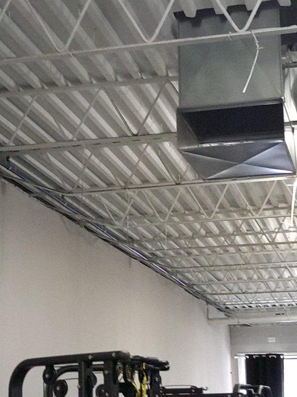 Installed water meter in commercial facility plumbing system. Created wall access opening to expose existing copper supply lines, installed brass fittings and blue-handled shutoff valve, and integrated new metering equipment into the water distribution system. All connections were secured and tested for proper operation.