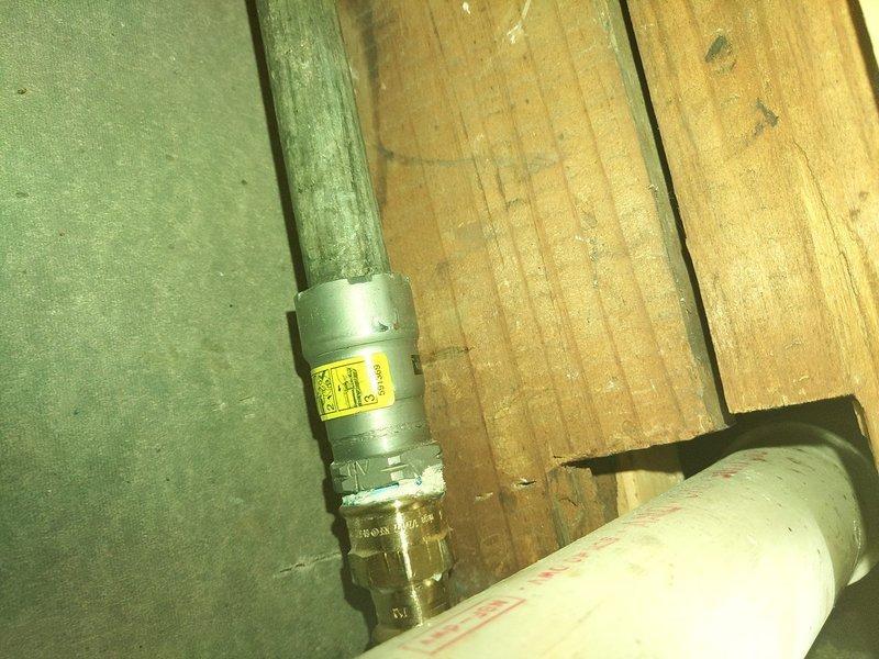 Responded to water leak in crawl space involving green-painted vertical supply pipe with compromised fittings and connections. Upon inspection, identified active leak at threaded pipe coupling with visible moisture damage to surrounding wooden floor joists and subflooring. Documented existing conditions showing deteriorated pipe assembly with metal clamps and brackets, noting significant water staining and potential mold growth on adjacent wall surfaces where moisture had accumulated. Provided estimate for permanent repair of affected piping system, as temporary measures would not prevent recurrence of leak. Recommended complete replacement of compromised pipe sections and fittings to ensure long-term resolution.