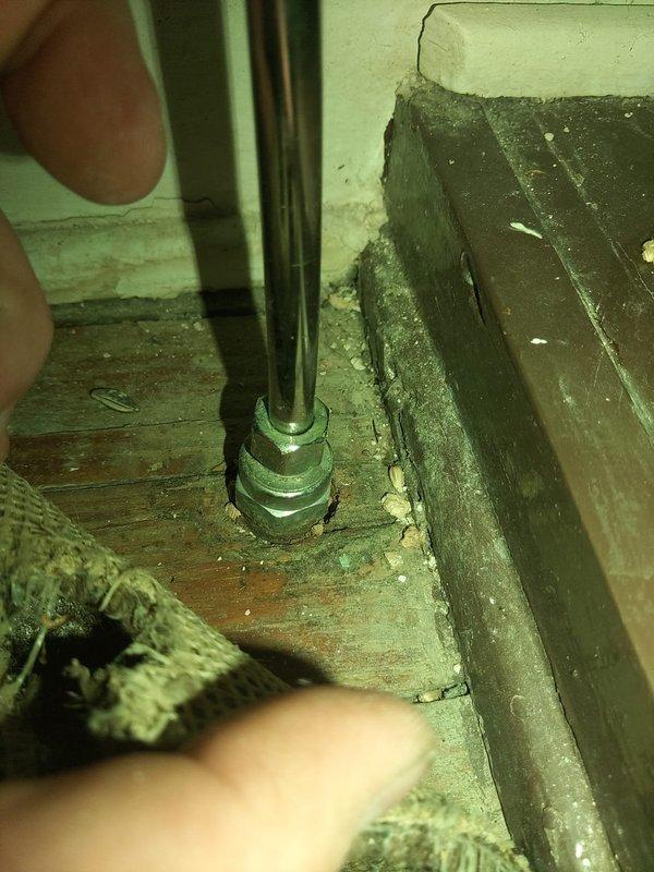Responded to water leak in crawl space involving green-painted vertical supply pipe with compromised fittings and connections. Upon inspection, identified active leak at threaded pipe coupling with visible moisture damage to surrounding wooden floor joists and subflooring. Documented existing conditions showing deteriorated pipe assembly with metal clamps and brackets, noting significant water staining and potential mold growth on adjacent wall surfaces where moisture had accumulated. Provided estimate for permanent repair of affected piping system, as temporary measures would not prevent recurrence of leak. Recommended complete replacement of compromised pipe sections and fittings to ensure long-term resolution.