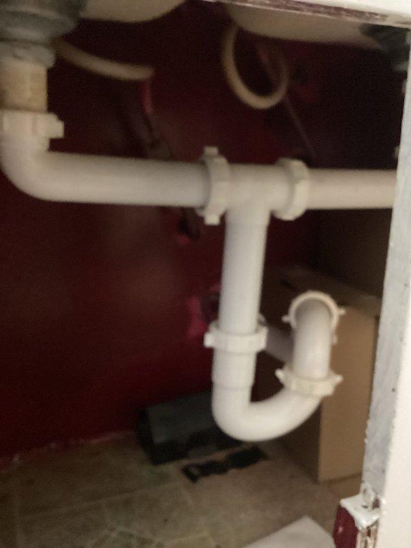 Responded to service call for frozen and damaged plumbing pipes beneath kitchen sink. Replaced compromised PVC drain assembly including P-trap configuration with new white PVC piping and fittings. Verified proper drainage flow and checked all connections for leaks before completing installation.