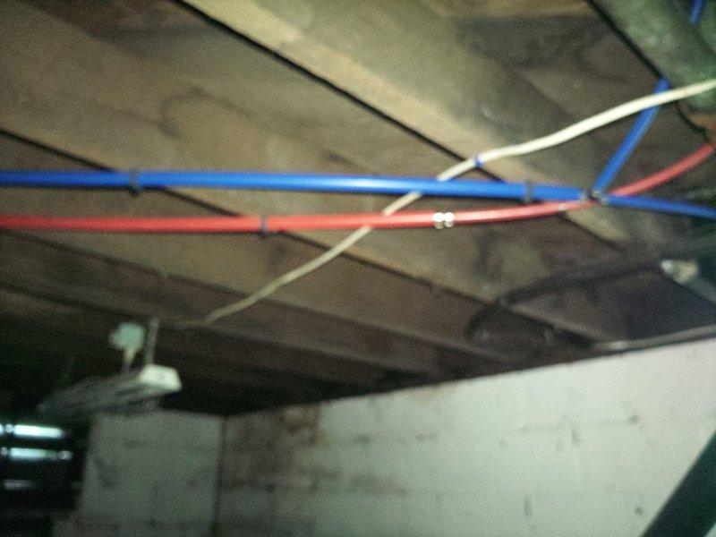 Replaced damaged waterlines with new copper piping and flexible supply lines. Installed brass fittings to connect vertical copper pipes to color-coded hot and cold water supply lines, secured the plumbing assembly to wooden backing board, and applied spray foam insulation around all pipe penetrations to seal gaps and prevent air infiltration. All connections were tested for proper flow and verified leak-free operation upon completion.