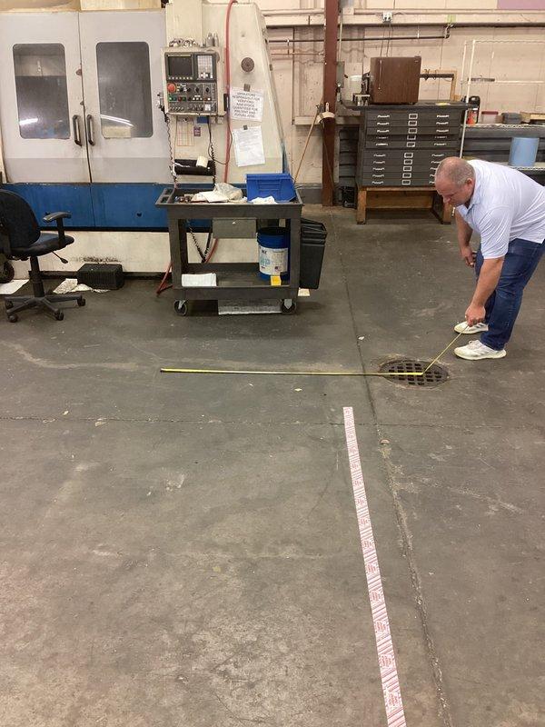Relocated existing floor drain approximately 5 feet to accommodate building addition at commercial manufacturing facility. Performed site assessment and measurements to determine new drain placement in concrete floor of active machine shop housing CNC equipment. Successfully repositioned main ground water drain to align with customer's expansion requirements while maintaining proper drainage function.