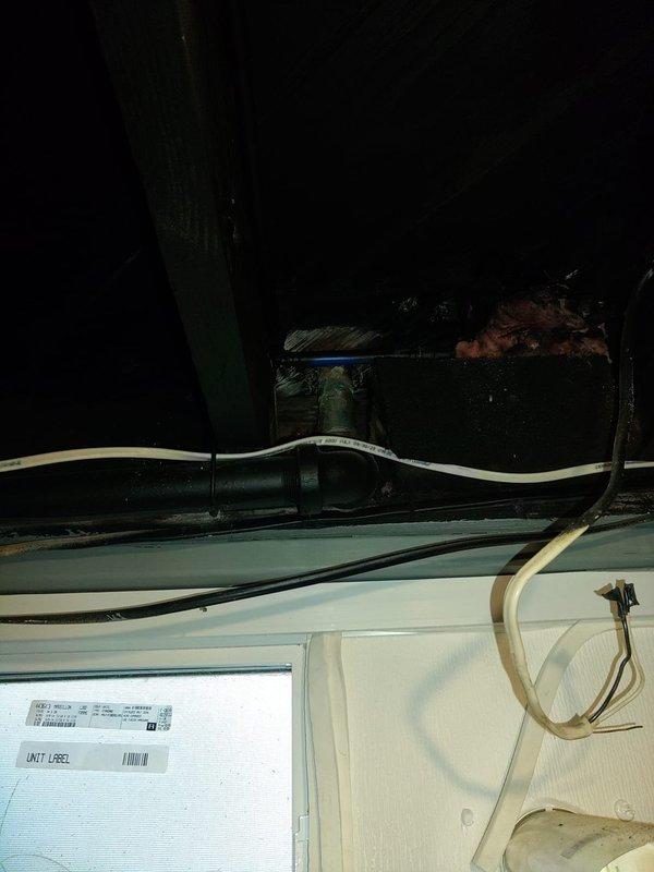 Responded to dual kitchen sink drainage issue in 1942-built home where previous plunging and chemical drain cleaner attempts had failed. Inspected under-sink plumbing configuration, identifying standard white PVC P-trap assembly beneath sink basin. Assessed drainage system for blockages, cleared obstruction in drain line, and restored proper flow to both kitchen sinks. Verified all connections secure and tested drainage performance to ensure complete resolution of backup issue.