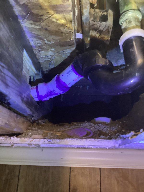 # Plumbing Service - Water Leak

Responded to a callback for an unresolved bathroom leak in an 80-year-old residence. Upon arrival, accessed the attic crawl space above the affected bathroom to investigate the source of the persistent leak. Inspection revealed compromised plumbing connections in the confined space where water supply lines interface with aged structural components.

Navigated through the tight attic access point to examine PVC piping and brass fittings located near HVAC ductwork and fiberglass insulation. Identified the leak source at a threaded pipe connection that had failed due to deterioration of the fitting and movement in the aging structure. The original repair from the previous visit had not addressed the root cause of the leak, which was related to settling and structural flex in the 80-year-old framing.

Performed necessary repairs to the compromised connection, ensuring proper sealing and support to prevent future movement-related failures. Documented the con