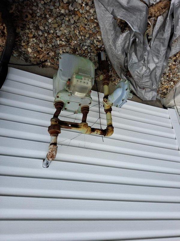 Installed 10 feet of gas piping with outside tap location to service HVAC equipment. Gas meter and shut-off valves with red handles were integrated into the installation, with proper connection to existing system. Permit was obtained through City of Streetsboro as required for compliance with local codes.