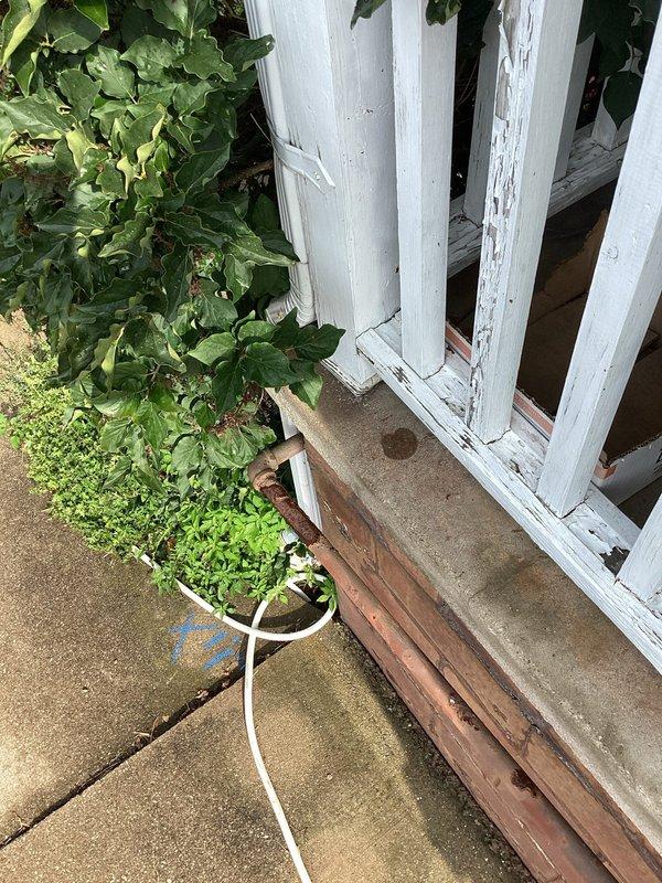 Performed camera inspection of downspout and sump pump drainage system to locate suspected break in underground line. Visual inspection confirmed downspout connection point at foundation and traced drainage path across exterior concrete surface using specialized camera equipment to identify failure point in the system.