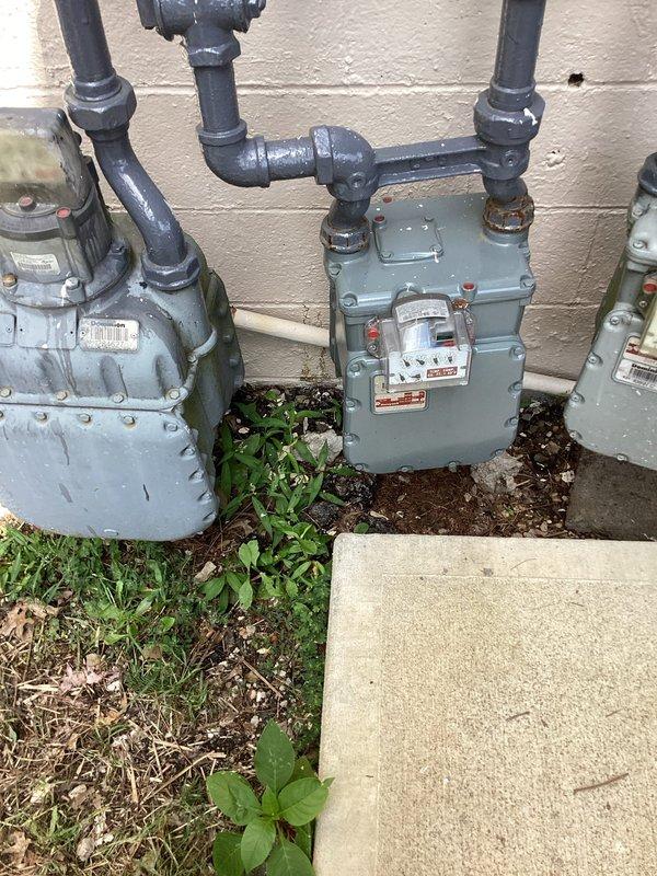 Responded to emergency call for high water bill with continuously running meter at multi-unit property. Investigated suspected water supply leak behind building near dumpster area and gas meter installation where ground saturation was reported. Conducted visual inspection of exterior utilities, piping infrastructure, and surrounding areas to locate source of water loss. Documented conditions of utility meter installations, ground moisture patterns, and parking lot utility access points for further assessment and repair recommendations.