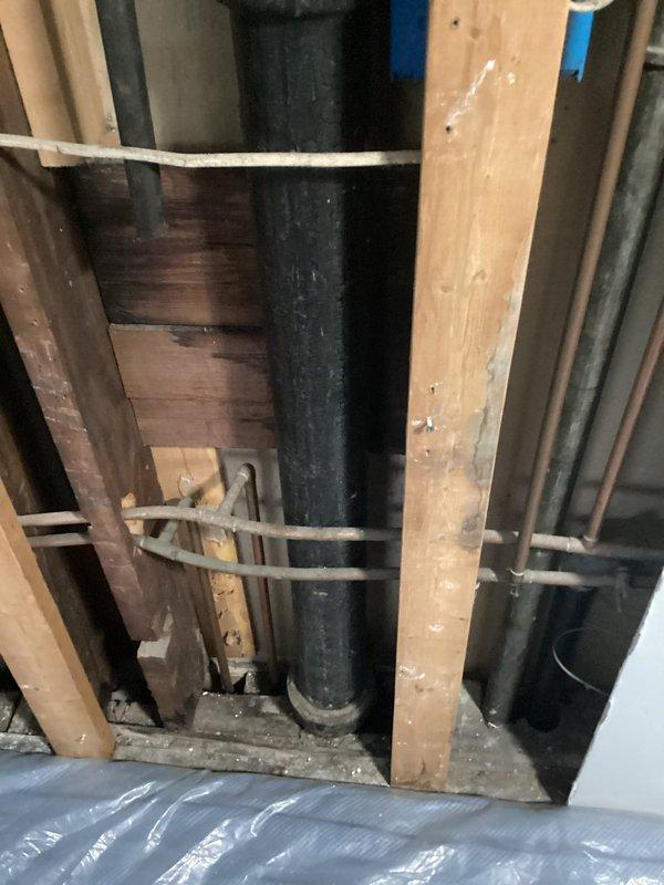 Replaced deteriorated galvanized main drain stack with new black ABS piping system. The existing galvanized stack had reached end of service life and required complete removal and replacement to prevent potential failures. New ABS pipes were properly secured to wooden framing members using approved strapping and brackets, ensuring code-compliant installation throughout the plumbing chase.