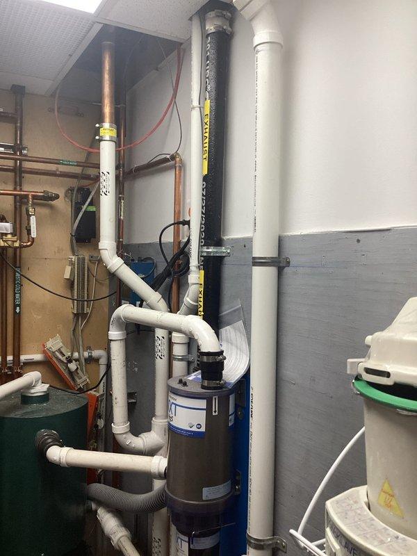Conducted site assessment of new commercial building to provide plumbing installation estimate. Evaluated existing mechanical room infrastructure including water heater, PVC supply and drain lines, copper piping, expansion tank, and associated fixtures to determine scope of work required for complete plumbing system installation. Documented current conditions and equipment layout with photographs for detailed estimate preparation.