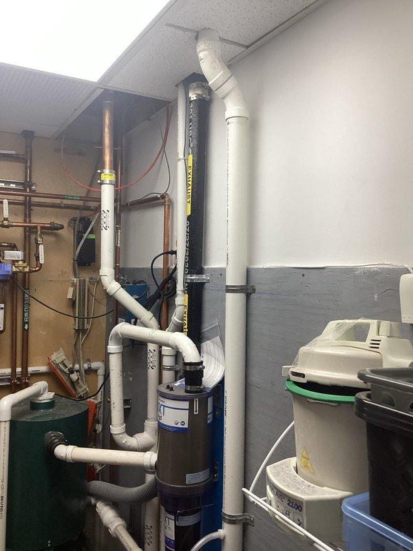 Conducted site assessment of new commercial building to provide plumbing installation estimate. Evaluated existing mechanical room infrastructure including water heater, PVC supply and drain lines, copper piping, expansion tank, and associated fixtures to determine scope of work required for complete plumbing system installation. Documented current conditions and equipment layout with photographs for detailed estimate preparation.