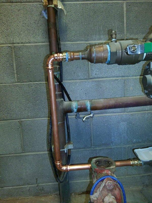 Responded to commercial property experiencing low water pressure issues. Successfully connected new waterline to existing house line, integrating copper piping with proper 90-degree fittings and secure wall mounting. Installation included backflow preventer with dual check valves, pressure regulation components, and expansion tank to ensure system compliance and optimal water pressure throughout the facility.