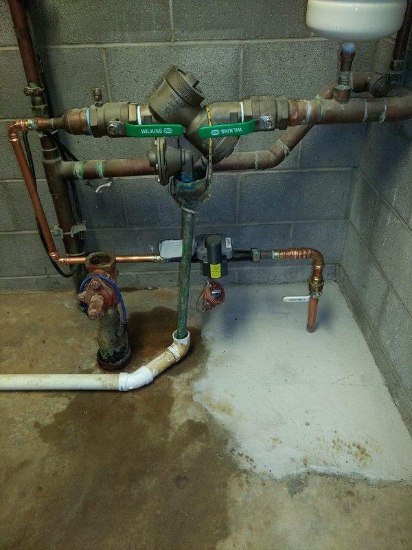 Responded to commercial property experiencing low water pressure issues. Successfully connected new waterline to existing house line, integrating copper piping with proper 90-degree fittings and secure wall mounting. Installation included backflow preventer with dual check valves, pressure regulation components, and expansion tank to ensure system compliance and optimal water pressure throughout the facility.