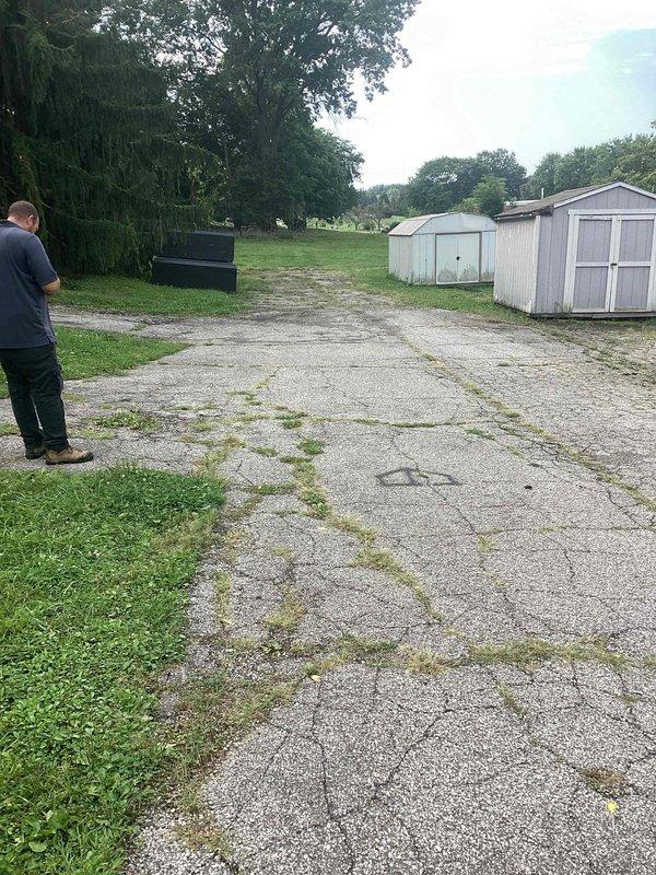 Responded to commercial no-water service call where building demolition had inadvertently disconnected the water supply line to the maintenance building. Assessed site conditions and determined that a new water line installation was required from the existing water meter to the maintenance building to restore service. Documented existing conditions including deteriorated driveway areas and site layout for upcoming water line installation work.