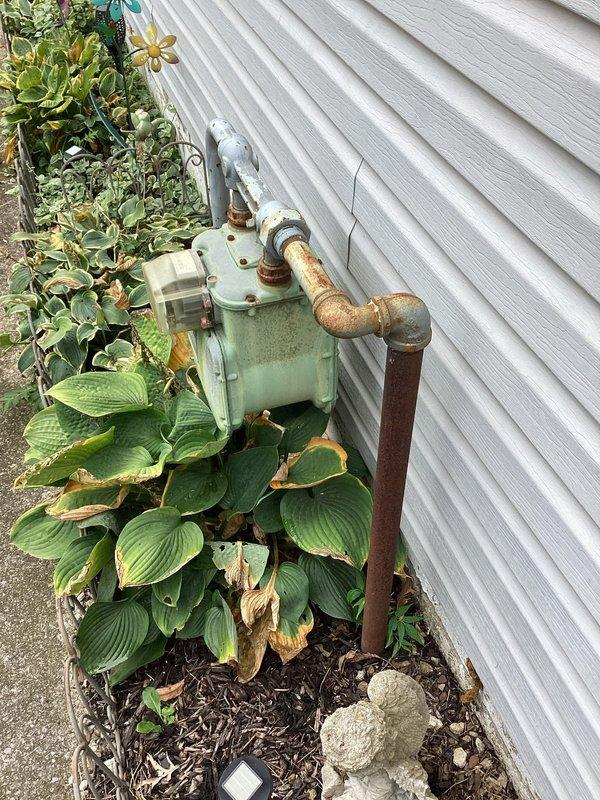 Replaced existing gas line from meter to building connection point. The previous copper piping showed significant weathering and oxidation, and was removed and replaced with new approved gas piping per code requirements, completing the second phase of gas line replacement at this residential property.
