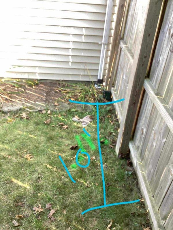 Responded to moisture intrusion issue at exterior wall of lower level split-level home in the downspout area. Upon inspection, identified groundwater drainage problem where downspout discharge was pooling near foundation, causing water penetration through the exterior wall. Marked utility locations and drainage path, assessed the existing downspout configuration and ground grading conditions. Documented site conditions showing inadequate drainage away from foundation and recommended corrective measures to redirect groundwater flow and prevent future moisture infiltration.