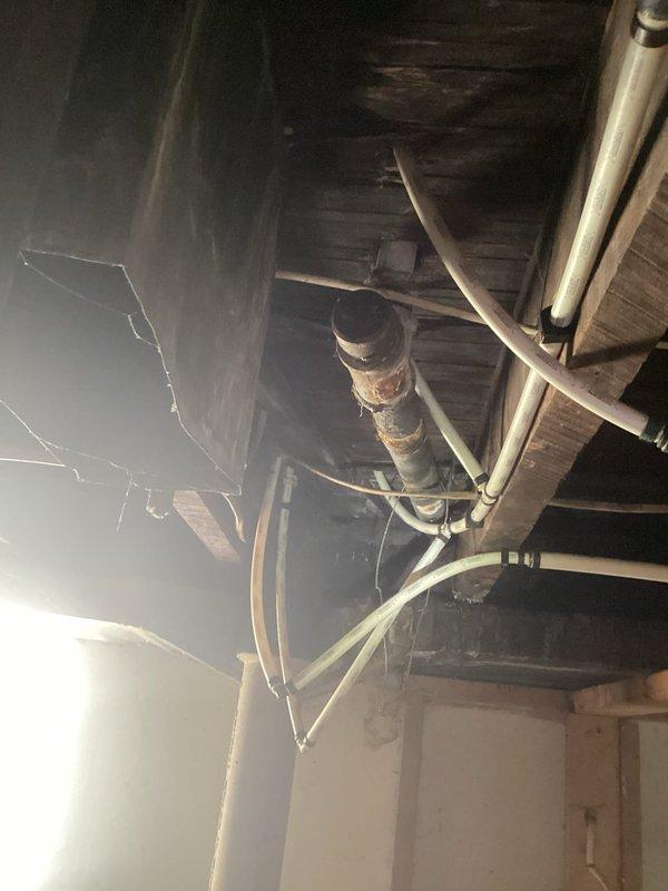 Responded to main sewer line clog causing multiple fixture backups, including two sinks. Performed main drain cleanout to clear blockage and restore proper drainage throughout the system. Documented existing infrastructure conditions in basement area, noting corroded cast iron piping and aging plumbing components that may require future attention.