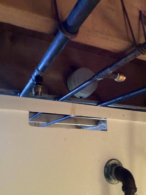 Responded to drainage issue where stand-up shower was improperly connected and draining into incorrect waste line as identified during home inspection. Accessed plumbing system through ceiling space and rerouted shower drain line to proper waste connection using PVC piping and appropriate fittings. Verified proper drainage flow and slope to ensure code compliance and prevent future backup issues.