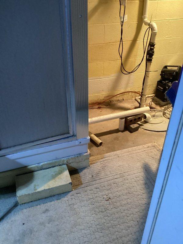 Responded to drainage issue where stand-up shower was improperly connected and draining into incorrect waste line as identified during home inspection. Accessed plumbing system through ceiling space and rerouted shower drain line to proper waste connection using PVC piping and appropriate fittings. Verified proper drainage flow and slope to ensure code compliance and prevent future backup issues.