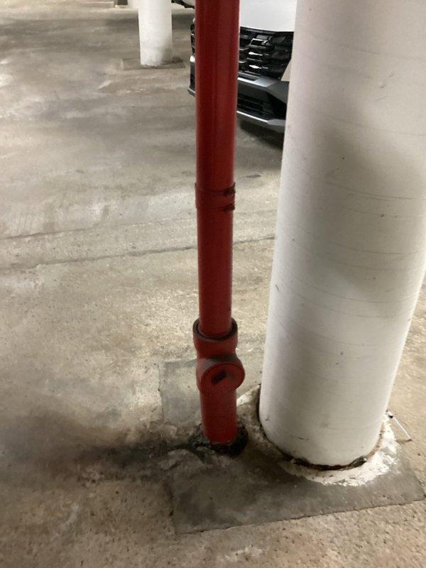 Responded to assess leaking drain pipes at multiple units in residential complex. Upon inspection, identified compromised drain line connections in underground parking area affecting several properties. Evaluated vertical drain pipes emerging from concrete floor, including one with threaded coupling joint showing signs of leakage, and documented existing pipe conditions and insulation wrapping for repair planning.