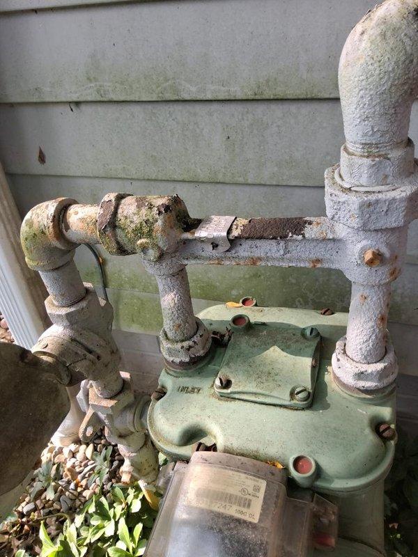 Completed installation of 10 feet of gas piping with outdoor tap location in Stark County under permit requirements. Successfully connected new gas line to existing meter assembly mounted on exterior vinyl siding, utilizing proper fittings and securing all connections to code specifications for safe natural gas delivery to the residence.