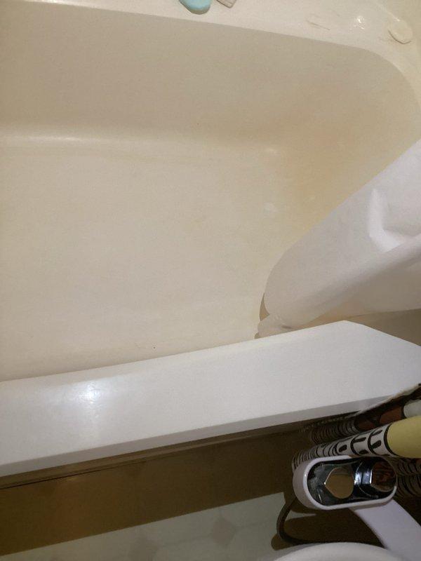 Responded to emergency water leak causing active damage to kitchen ceiling below upstairs bathroom. Upon arrival, inspected bathroom fixtures and identified source of leak at bathtub drain assembly with failed seal allowing water penetration through subfloor. Removed existing drain components, cleaned surfaces of mineral deposits and debris, and installed new drain gasket and tightened connections to manufacturer specifications. Conducted water flow test to verify repair integrity and confirmed no further leakage. Advised that kitchen ceiling drywall repair will be required once affected area has adequately dried, with recommendation to monitor for 24-48 hours before proceeding with restoration work.
