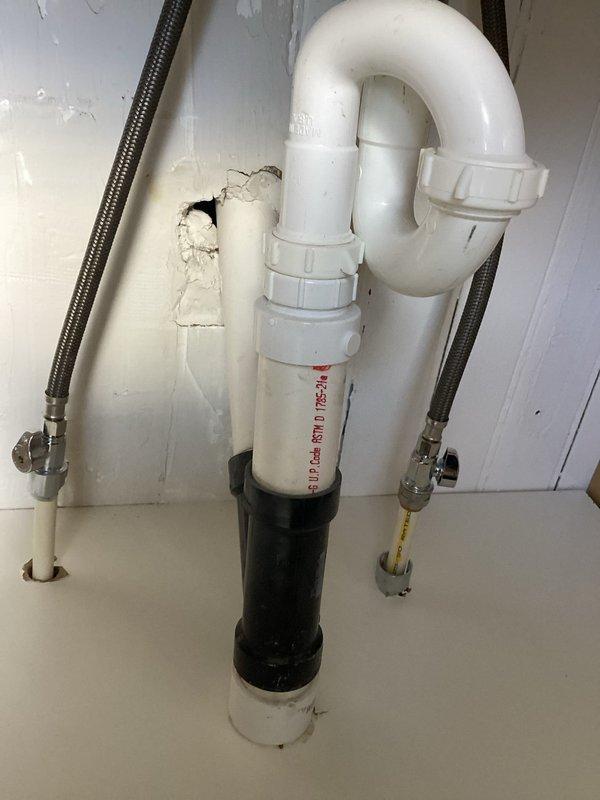 Performed inspection of plumbing installation completed by another contractor at the request of property manager. Evaluated under-sink plumbing assembly including P-trap configuration, PVC drain lines, and braided stainless steel supply lines with shut-off valves, noting functional condition with minor wear. Inspected newly installed shower head assembly with chrome fixture and wall-mounted arm, confirming proper installation and operation.