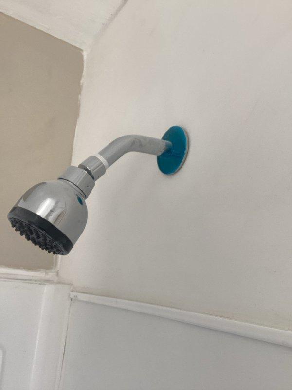 Performed inspection of plumbing installation completed by another contractor at the request of property manager. Evaluated under-sink plumbing assembly including P-trap configuration, PVC drain lines, and braided stainless steel supply lines with shut-off valves, noting functional condition with minor wear. Inspected newly installed shower head assembly with chrome fixture and wall-mounted arm, confirming proper installation and operation.
