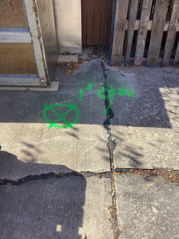 Responded to drainage backup issue where downspouts were overflowing into underground drain system. Upon arrival, inspected exterior drainage components and documented existing conditions including utility markings and concrete surface deterioration near the affected drain area. Assessed downspout connection points and underground drainage infrastructure to identify blockage source and verify proper water flow capacity.