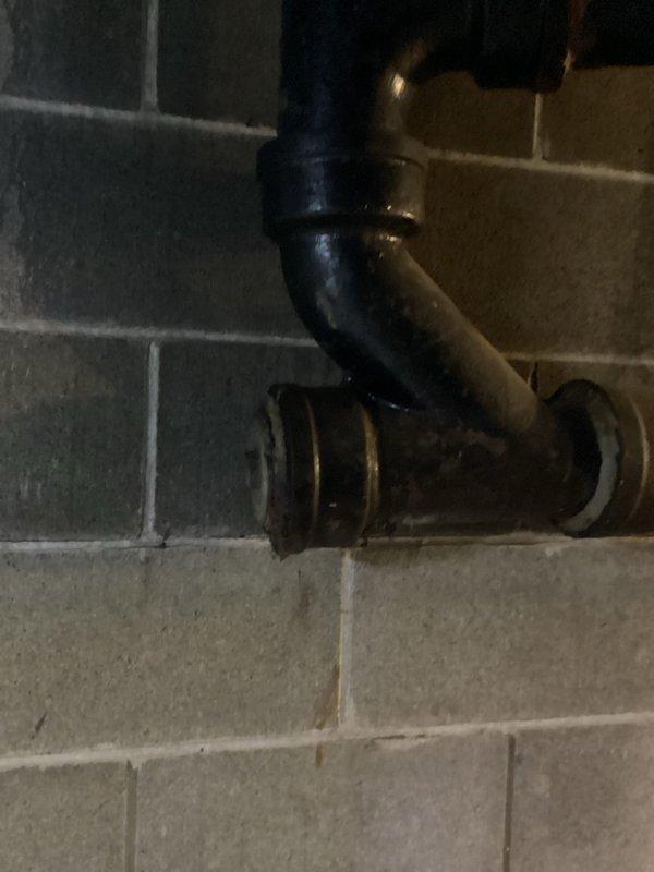 Inspected and diagnosed multiple leaks, including a broken sump pump discharge pipe at the crock, a leaking bathroom sink P-trap, an upstairs bathtub drain leaking into the lower level, and a leaking valve. Documented the corroded cast iron drain stack and couplings in the basement and the damaged sump pit discharge piping, and provided an estimate for stack replacement and necessary repairs.