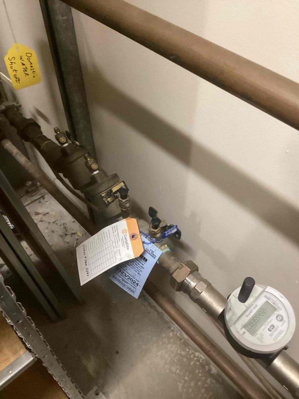 Performed annual backflow prevention assembly testing on two devices: a Watts reduced pressure assembly serving the domestic water supply, located indoors in the stock room, and a Febco assembly serving irrigation, located on the building exterior. Both assemblies were inspected, tested per applicable standards, and documented with photographs of the full device and serial plate. Completed test reports with brand, model, serial number, size, location, and service protected were prepared for submission to the water purveyor.