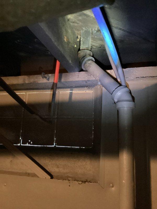 Responded to a clogged kitchen sink and inspected the drain line from the under-sink cabinet through the accessible basement drain piping, including the P-trap, elbow fittings, and branch connections. Cleared the obstruction from the drain line, restoring proper flow, and verified normal drainage at the fixture.