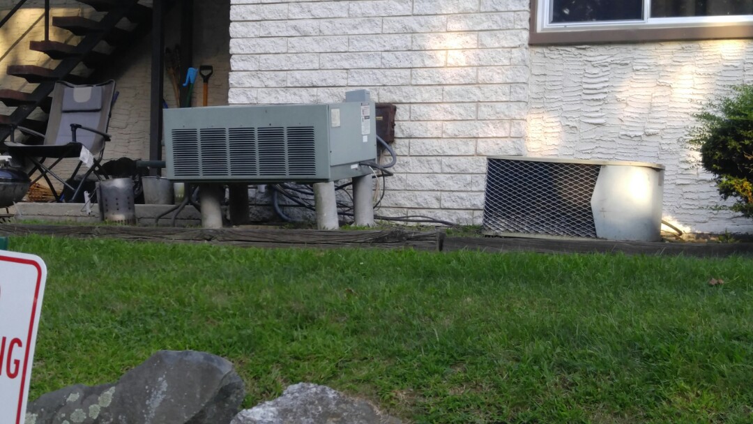 Unlevel air conditioner outside.