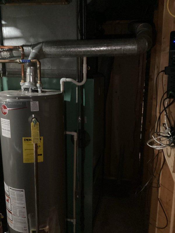 Conducted comprehensive evaluation of 47-year-old furnace in basement. Unit shows significant age deterioration and is positioned in a confined utility space alongside a Performer Platinum water heater. Recommended complete replacement due to equipment age exceeding standard operational lifespan, which presents efficiency concerns and potential safety risks. Provided customer with replacement options suitable for the existing installation configuration.