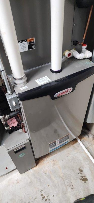 Performed annual heating maintenance on customer's 2-year-old Lennox forced-air furnace located in basement. Inspected and cleaned all components including condensate lines, verified proper operation of electrical connections and gas valve assembly, and confirmed system is functioning correctly. Unit is in good condition with warranty coverage extending to 2025.