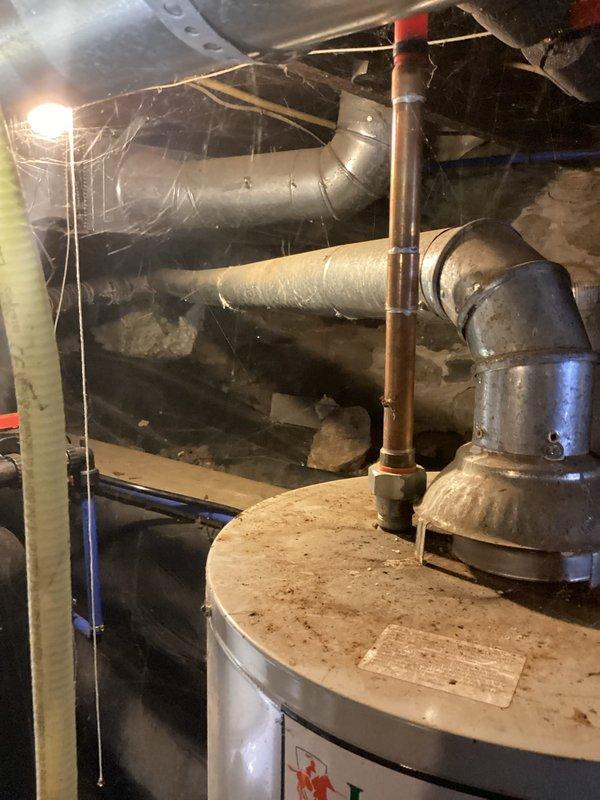 Conducted inspection of 32-year-old furnace after previous technician condemned heat exchanger and blower motor. Confirmed failure of both components during visual assessment. Documented existing installation in mechanical room, noting significant age-related deterioration and suboptimal installation environment with dust accumulation and confined space constraints.