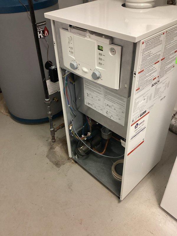 Performed scheduled boiler maintenance service on Bosch heating system. Inspected internal components including circulation pump, control panel, and electrical elements. System functioning properly with temperature set at 68°F, no issues detected.