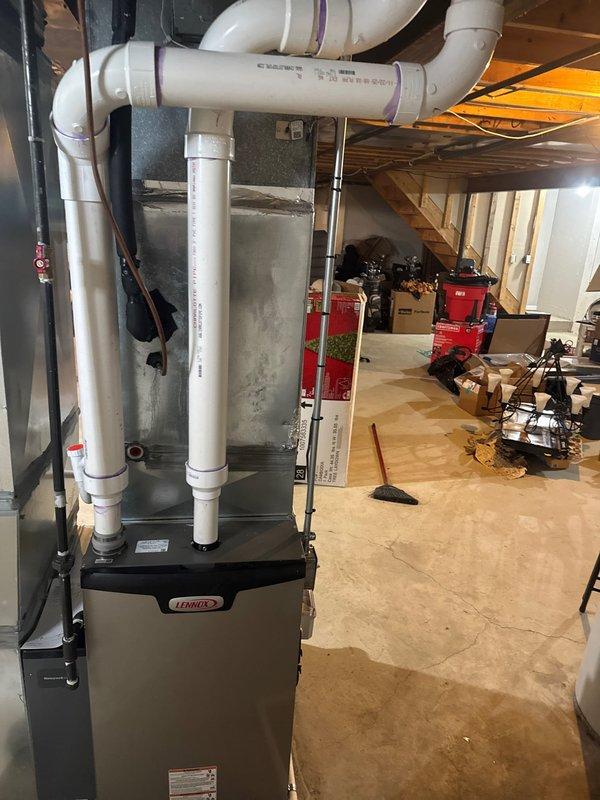 Successfully installed new Lennox furnace with S40 thermostat in basement utility room. Complete installation included proper connection of metal ductwork, PVC ventilation pipes with sealed joints, and all necessary condensate drainage components. System was fully tested and is operating according to manufacturer specifications.