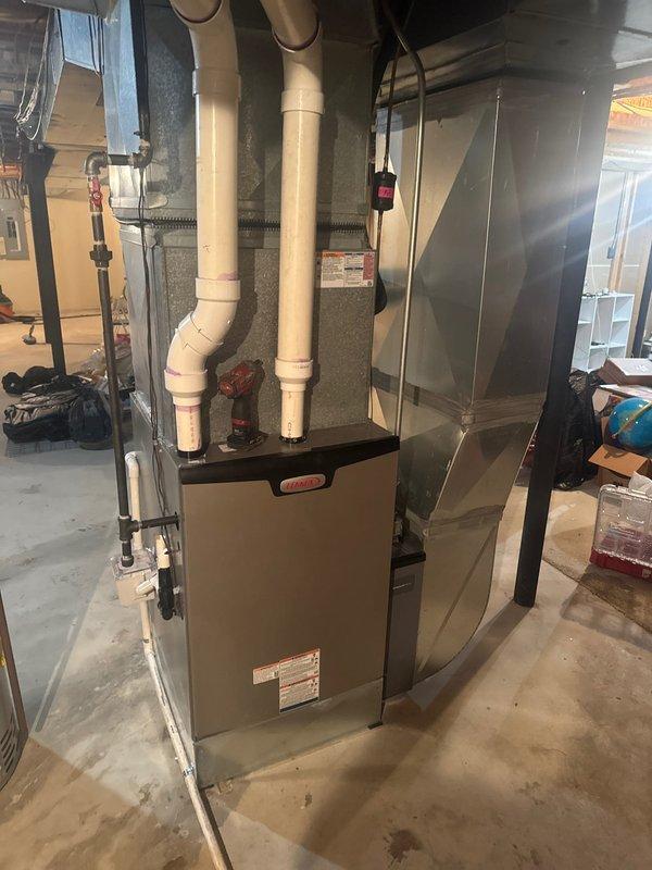Successfully installed a Lennox furnace unit with S40 thermostat in basement utility area. Replaced existing humidifier drain lines and properly connected all ventilation components using PVC piping. System was tested and confirmed operational prior to completion.