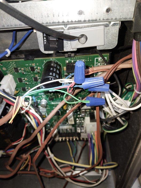 Inspected thermostat communication with furnace after recent maintenance. Verified proper wiring connections at the circuit board, ensuring all control wires (white, blue, brown, green, yellow, and pink) were properly secured with wire nuts. Confirmed system functionality with successful communication between thermostat and furnace.