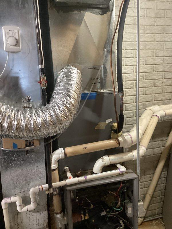 Inspected 20-year-old non-operational furnace system located in basement. Evaluation revealed outdated equipment with significant wear on metal casing, ductwork connections, and electrical components. Recommended full replacement of existing natural gas furnace and associated ductwork to restore heating functionality.