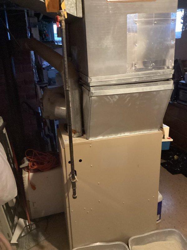 Conducted comprehensive inspection of 25+ year old HVAC system located in basement showing signs of malfunction. System includes standard furnace unit with metal ductwork connections and nearby electrical panel. Recommended full system replacement due to age and deteriorating performance.