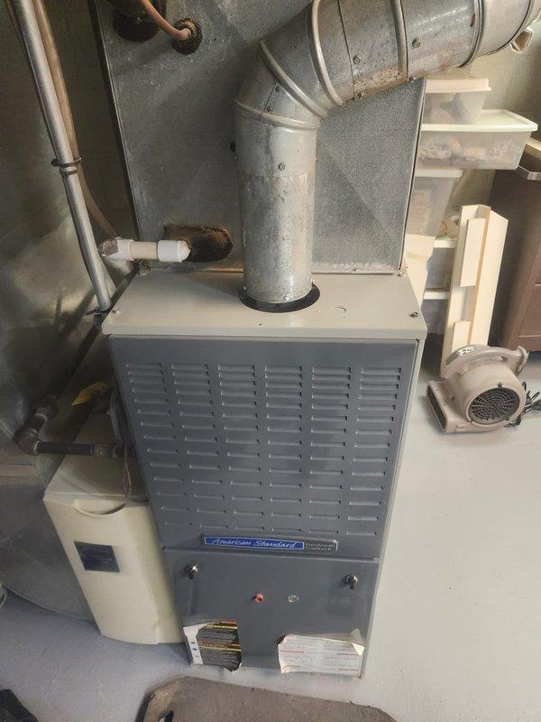 Responded to no heat complaint on aging American Standard furnace system. Performed diagnostic testing using digital analyzer which revealed faulty ignition sequence. Cleaned flame sensor and control board connections, replaced worn blower motor capacitor, and verified proper gas valve operation. System now functioning with normal heat output and proper cycling.