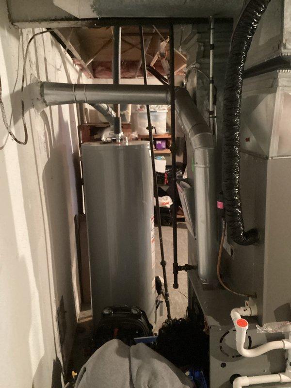 Completed evaluation for replacement of aging HVAC system in residential utility room. Current setup includes A.O. Smith water heater with copper piping and a separate furnace unit with PVC venting. Recommended full system replacement due to inefficient ductwork configuration and limited space constraints in the unfinished basement area.