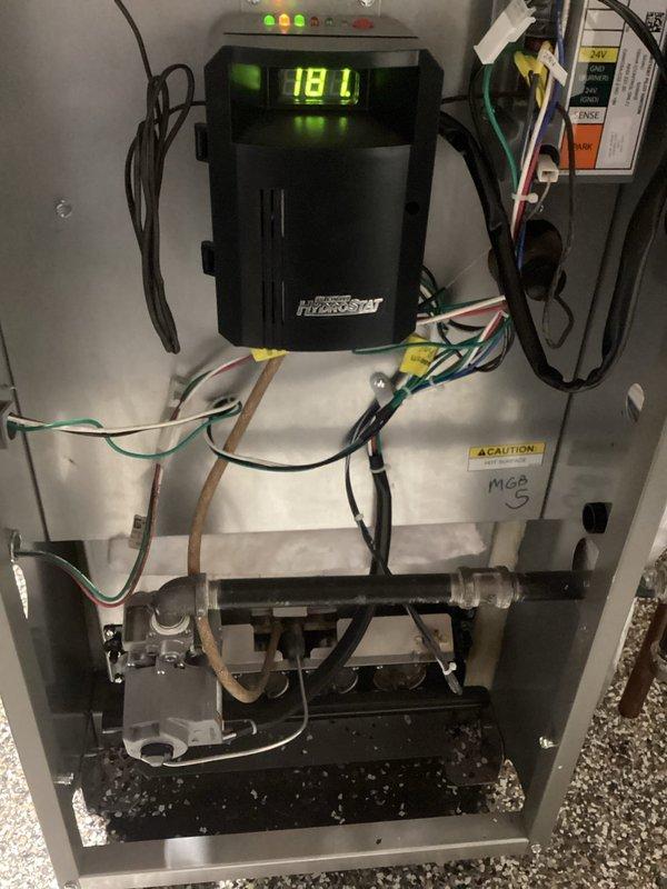 Performed annual boiler maintenance service, which included inspection of control unit, verification of operating parameters (digital display reading 181), and examination of gas valve assembly. System components including expansion tank, circulation pump, and copper piping were inspected and found to be in proper working condition. All connections were secure with no signs of leaks or malfunctions observed in the mechanical room setup.