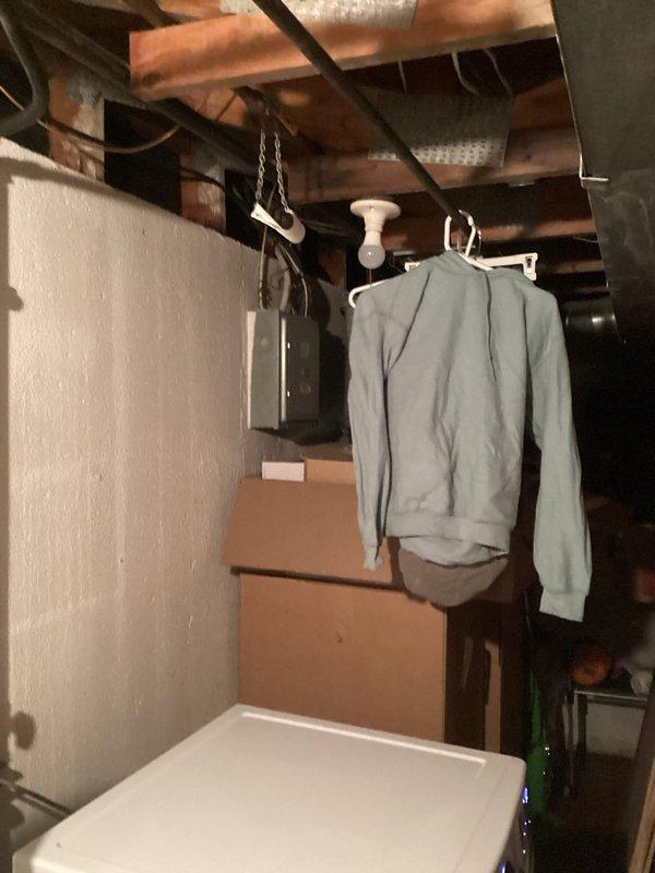 Conducted HVAC system replacement evaluation in residential basement utility area. Inspected existing furnace unit with connected ductwork and air handler component (Kane brand visible). Assessment included examination of installation space constraints, existing ductwork condition, and electrical connections for proper replacement specifications.