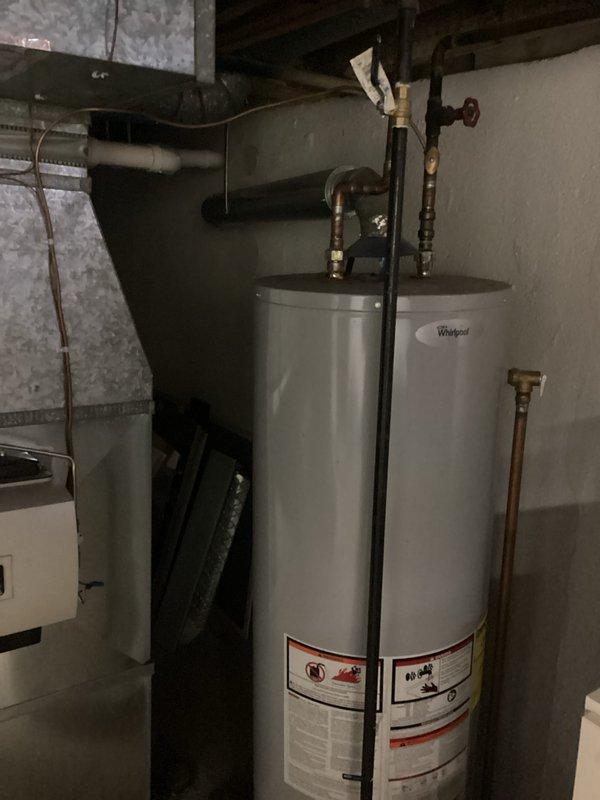 Conducted inspection of existing Whirlpool water heater unit for potential replacement. Evaluated current plumbing connections including copper supply lines, drain configuration, and shutoff valve functionality. Provided customer with replacement options and installation estimate for new water heater system.