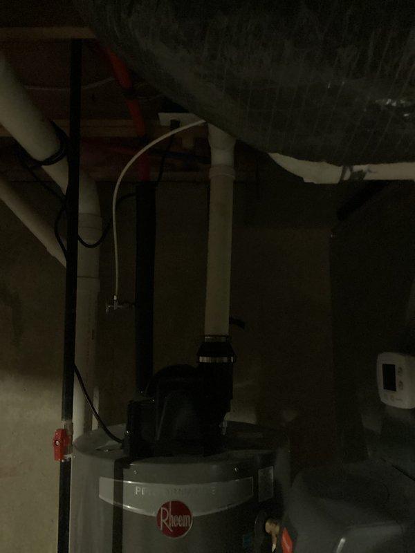 Performed assessment of 10-year-old Rheem water heater located in basement requiring replacement. Documented existing installation including PVC venting configuration, gas line connections, and water supply piping. Provided estimate for complete water heater replacement service including proper disposal of existing unit and installation of new system with all necessary code-compliant connections.