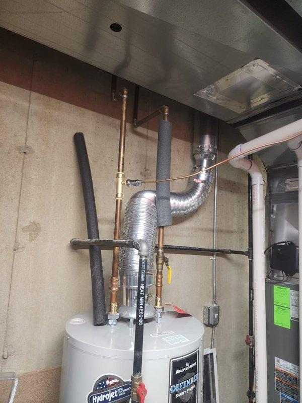 Diagnosed humidifier (HUM) malfunction affecting zones 5-9. Inspected water heater and associated plumbing connections. Examined HVAC system including furnace/air handler, ductwork, and ventilation components for potential relationship to humidity control issues.